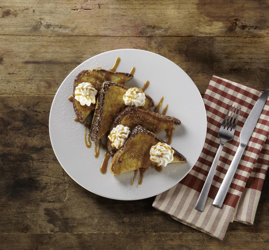 Cinnamon French Toast · Thick slices of cinnamon swirl bread battered in our signature french toast dip, dusted with cinnamon sugar and topped with whipped cream and caramel sauce, served with a side of syrup.