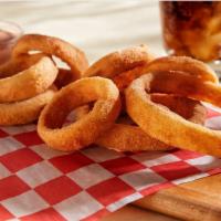 Hand-Breaded Onion Rings · Prepared fresh daily and served with zesty sauce.