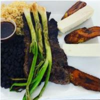 EL Churrasco · skirt steak served with Onions, fried plantains , rice, black beans, Queso fresco