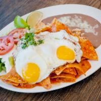 Chilaquiles con Huevo · Fried corn tortilla with eggs. Served with rice, beans, lettuce, guacamole, and sour cream. 