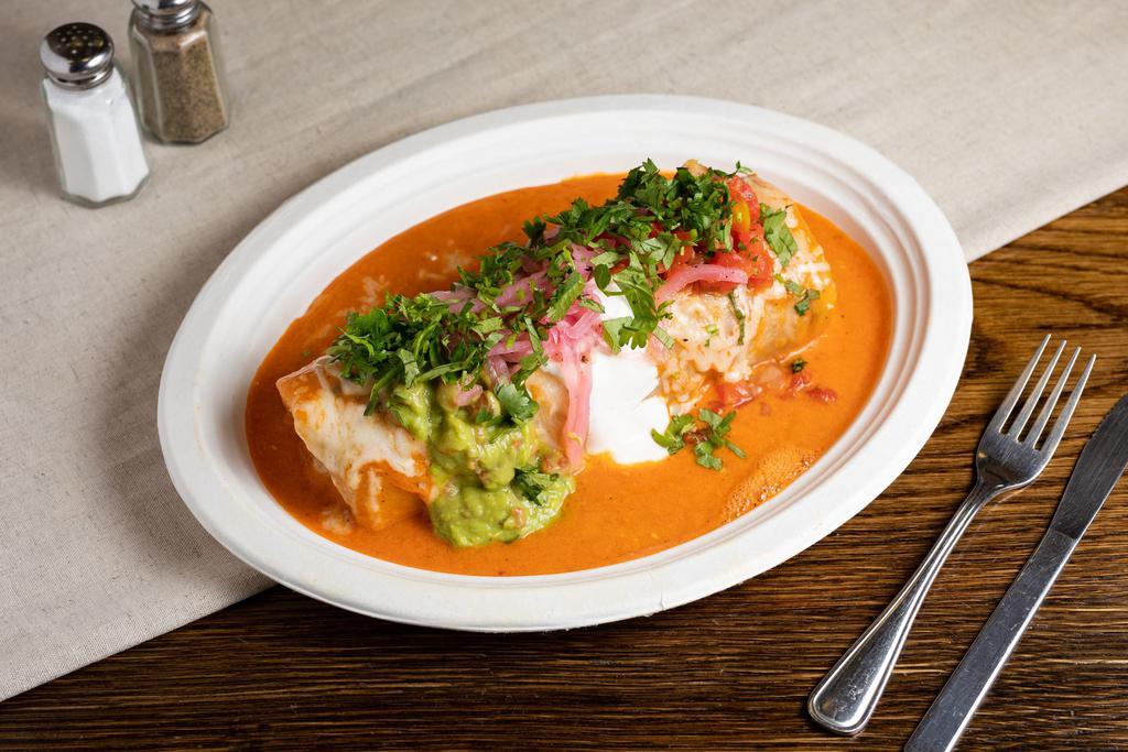 Special Mojado Wet Burrito · Choice of meat, rice, beans, topped with enchilada sauce, melted cheese, guacamole, sour cream and salsa.
