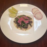 Regular Beyond Vegan taco · Corn tortillas, beyond meat, taco sauce, cilantro, onion 