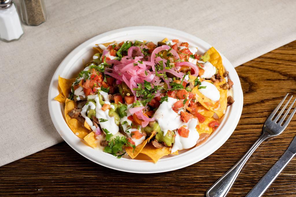 Super Nachos · Any meat, tortilla chips, beans, melted jack cheese, sour cream, guacamole and salsa.

