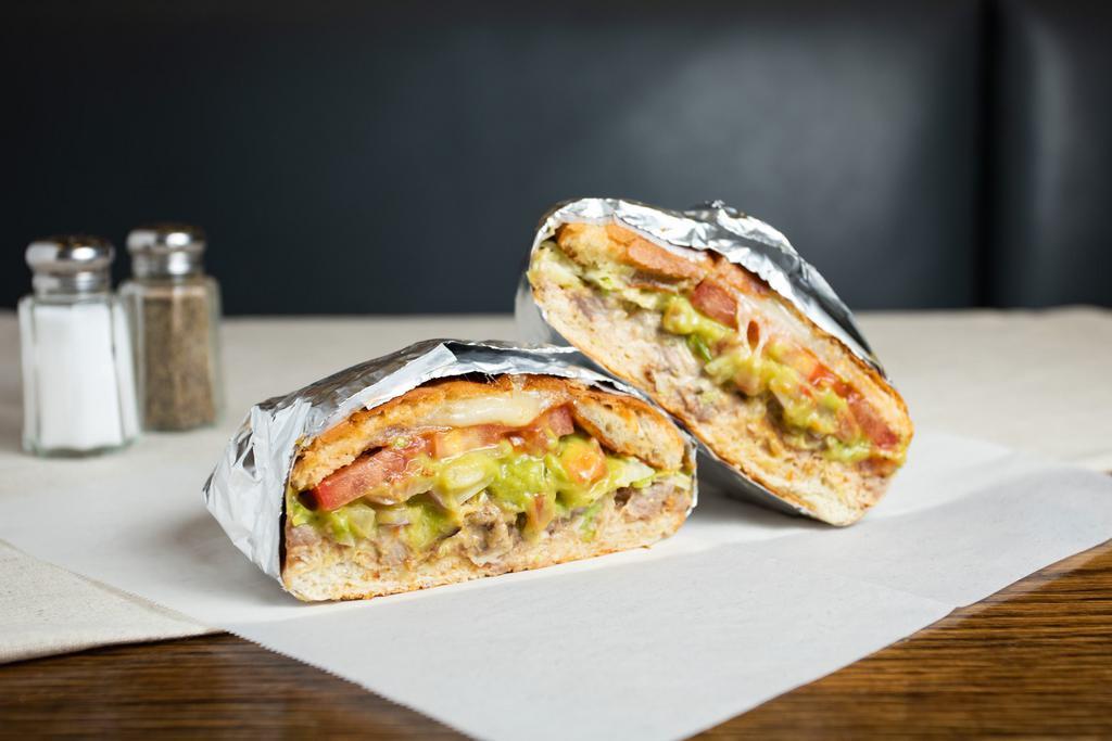 Torta · Toasted Mexican bread with choice of meat, refried beans, cheese, sour cream, tomato, lettuce and guacamole. 