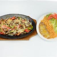 Alambres · Chunks of beef steak, onions, bell pepper, bacon, rice, beans, sour cream, guacamole, salad ...