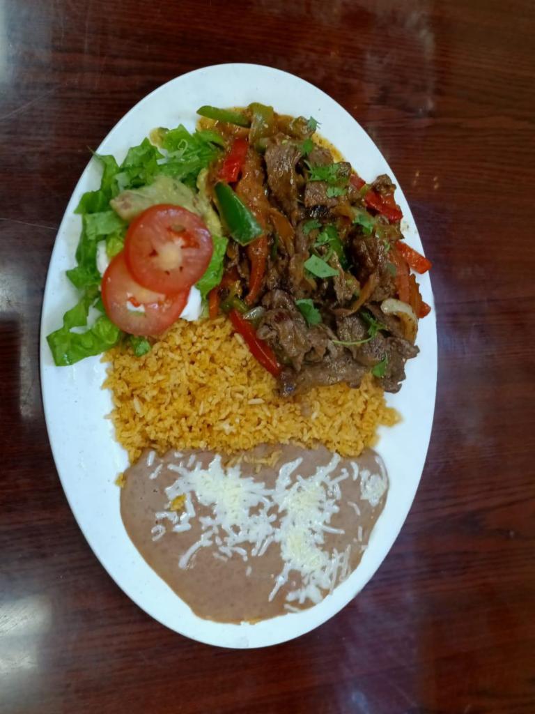 Bistec Ranchero · Mexican style grilled beef steak, beans, rice, sour cream, guacamole, salad and tortillas.
