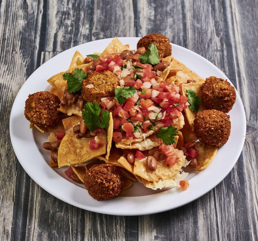 Nachos · Tortilla chips, Jack cheese, beans, choice of meat, pico de gallo, and Mexican salsa.
