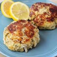 Crabcakes  · 2 crabcakes made with lumps of crabmeat and love 
Served with 1 side and roll.