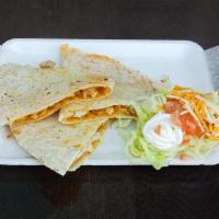 Quesadillas · Flour tortilla with mix cheese and choice of meat. Served with lettuce, tomato, and sour cre...