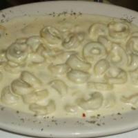Meat Tortellini Alfredo · Ring shaped pasta with meat and rich butter and Parmesan sauce.