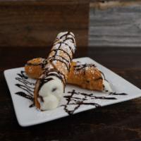 Cannoli · 2 Italian pastry filled with sweet creamy ricotta cheese and chocolate chips then topped wit...