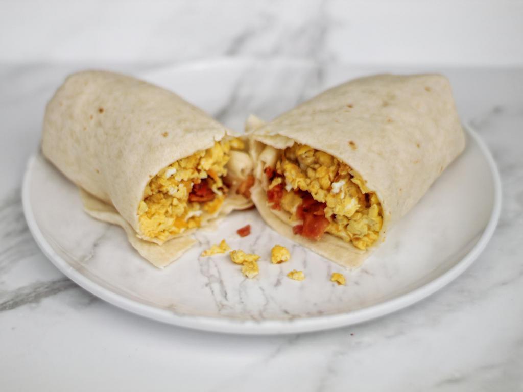 Breakfast Burrito · A Shack Favorite! Scrambled eggs, cheddar cheese and potatoes with your choice of a bacon, sausage, or mixed meats .  Add a side of green chili for an extra kick!