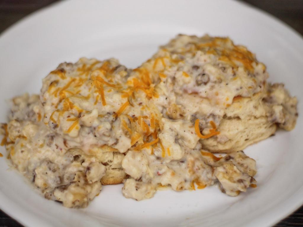Biscuits and Gravy · Two soft buttermilk biscuits covered in homemade sawmill sausage gravy.