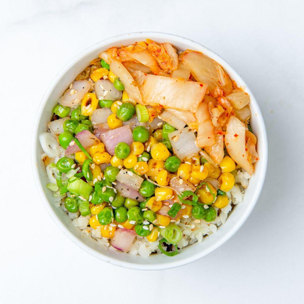 Kimchi Cauliflower Fried Rice · Roasted cauliflower rice, vegan kimchi, peas, corn, green onions, and sesame seeds with our house-made ginger garlic sauce and a protein of your choice. Gluten-Free.  