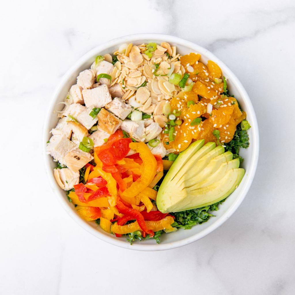 Sesame Chicken Salad · Chopped kale, antibiotic-free roasted chicken, mandarin oranges, avocado, sliced peppers, roasted almonds, green onions, sesame seeds, and creamy sesame dressing (served on the side). Gluten-Free.  
