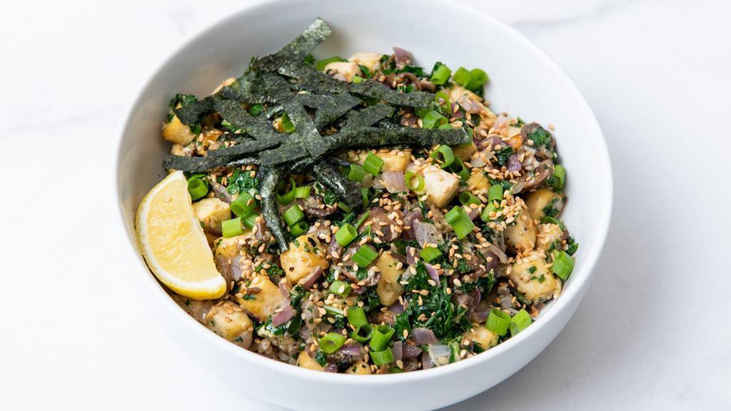 Sesame Surprise · Sesame tofu with roasted corn, sauteed mushrooms, charred peppers, citrus-marinated kale, seasoned seaweed, caramelized onions, green onions, sesame seeds and our creamy sesame sauce. Served with a lemon wedge and a base of your choice. Gluten-free. Vegan.