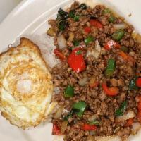 Pao Kra Pow · Ground chicken or pork. Thai basil, bell pepper, onion, topped with a fried egg.