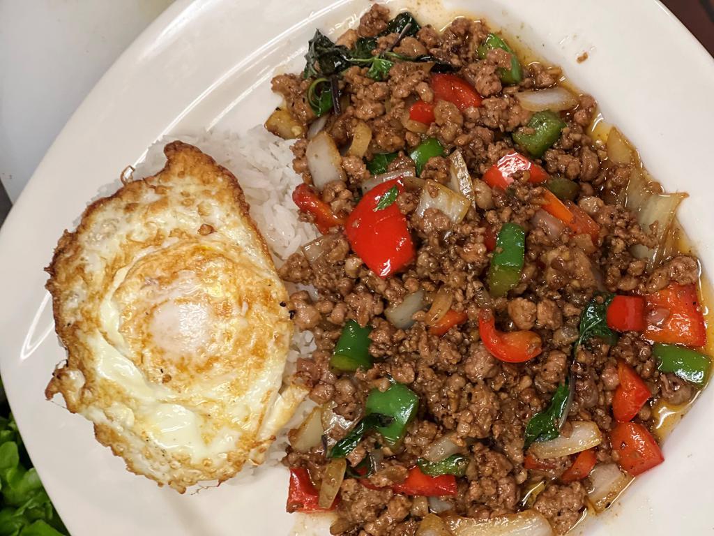 Pao Kra Pow · Ground chicken or pork. Thai basil, bell pepper, onion, topped with a fried egg.