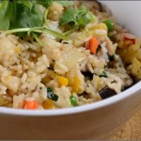 Pineapple Fried Rice · Stir-fried rice with eggs, pineapple, peas, carrots, and onions.