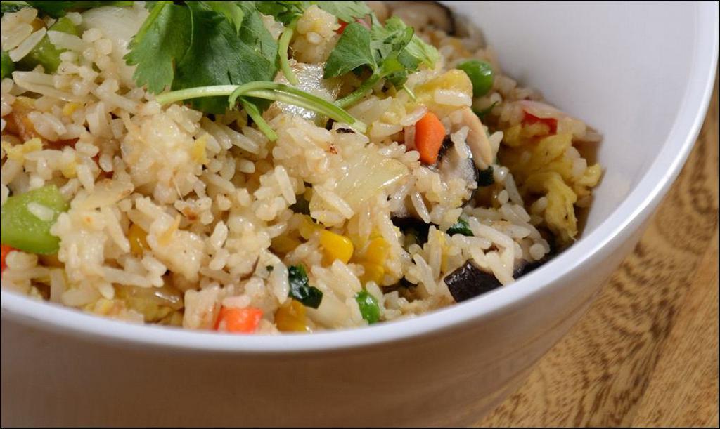 Pineapple Fried Rice · Stir-fried rice with eggs, pineapple, peas, carrots, and onions.