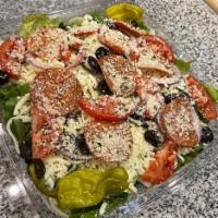 Italian Salad · A large bed of romaine lettuce, tomatoes, black olives, red onions, cheese, pepperoni and pe...