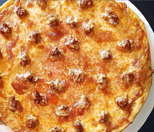 Creamy Garlic and Sausage Pizza · Gluten free option available. This tasty disc is based with our house made creamy garlic dressing and topped with our own Italian sausage and mozzarella cheese.
