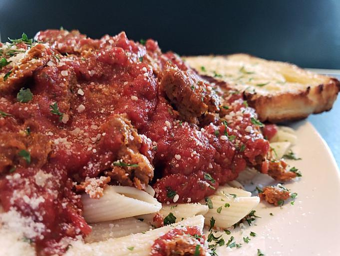 Penne with Red Sauce · Penne pasta served with our own Mama Mia's Red sauce. Add a meatball, our won Italian sausage and cheese for an additional charge. Served with garlic bread. Salad available à la carte.
