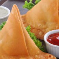 Samosa · 2 pieces. Minced potatoes and peas wrapped in pastry dough and fried.
