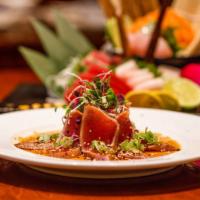 Tuna Tataki · Thinly sliced, served with ponzu sauce, and sesame seeds.