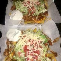 Nacho Supreme · Steak, ground beef, chicken or pork. Sour cream, lettuce, cheese, tomatoes and peppers.  ( L...