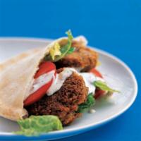 Falafel Sandwich · Deep fried ground chickpeas served on pita bread and topped with lettuce, tomatoes, pickles ...