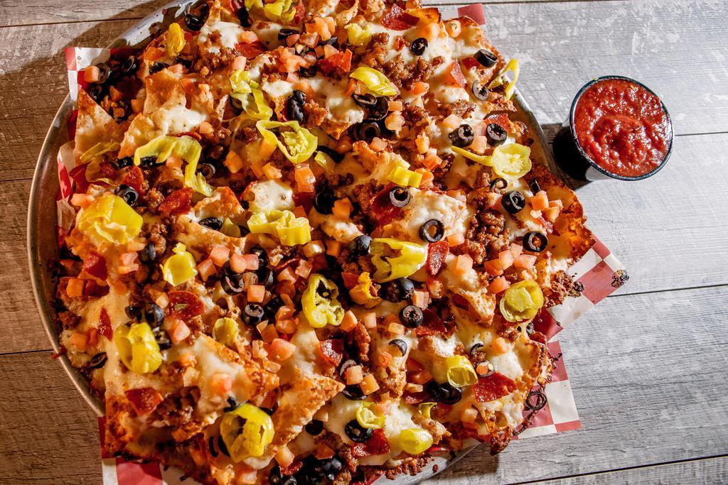 Italian Nachos · Light and airy wonton chips, smothered in Alfredo sauce, melted hand-grated mozzarella, pepperoni, Italian sausage, pepperoncini, black olives, diced tomatoes and red pepper relish. Served with homemade marinara.