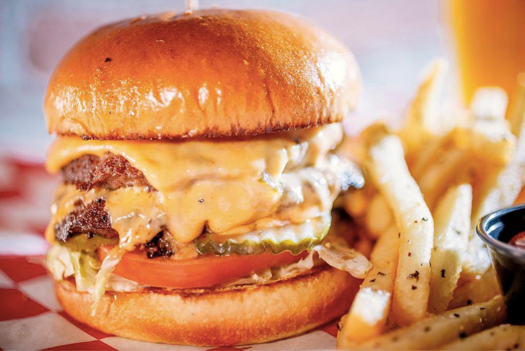 The Burger · Two 1/4 lb. patties, topped with lettuce, tomatoes, pickles, melted American cheese and Parry’s burger sauce.