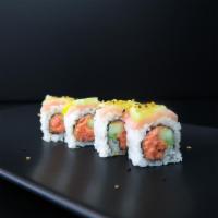 Champa Roll · Spicy tuna, cucumber topped with yellow tail, lemon, sesame sauce .