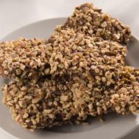 English Toffee · crisp buttery toffee enrobed in milk or dark chocolate, sprinkled with roasted almond pieces.
