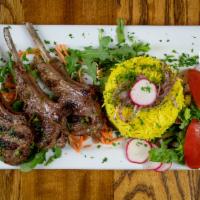 Lamb Chops Plate (3 pieces) · Three lamb chops marinated with Arabic spices. Served with rice, and a side of salad.