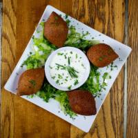 Lebanese Beef Croquettes (Kibbeh) 4 pieces · 4 pc of Ground beef, groats, onions, Pine nuts, made into balls and deep fried.