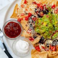 Vegetarian Nachos · Tortilla chips, beans, melted Jack cheese, lettuce, sour cream, guacamole and salsa. Veggie. 
