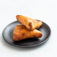 Vegetarian Sambosa · 2 pieces. Well seasoned lentil in a pastry, cooked crispy.