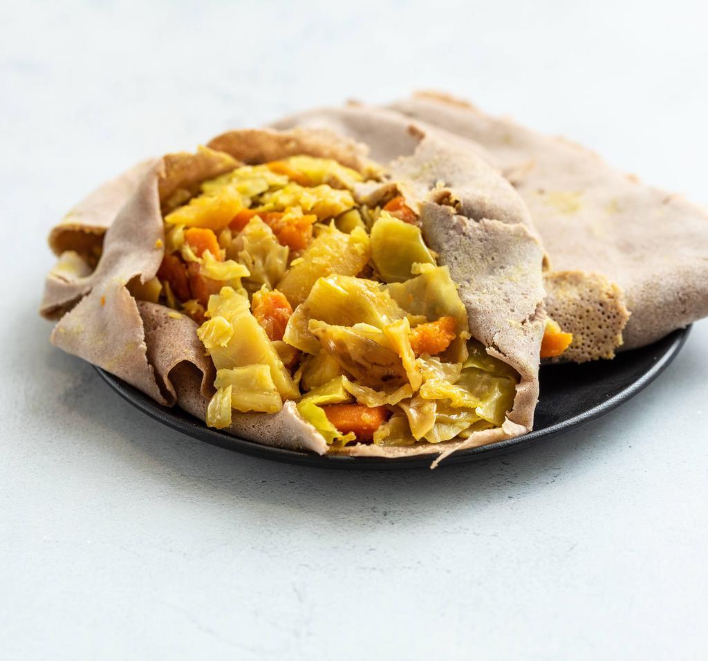 Tikil Gomen · Cabbage, carrots and potatoes in turmeric.