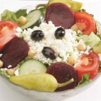 Leo's Famous Greek Salad · Served with lettuce, cucumber slices, pepperoncini, Greek olives, beets, chickpeas, feta che...