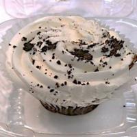 OREO® Cookie Cupcake · A rich chocolate cupcake topped with vanilla cream and real OREO® cookie bits.