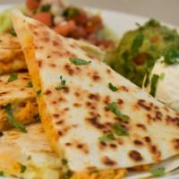 Quesadillas · Grilled flour tortillas with mozzarella cheese and your choice of meat. Side of iceberg lett...