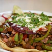Alambre · Made with asada steak or pastor BBQ pork, sauteed in butter and sweet peppers, onions, pinea...