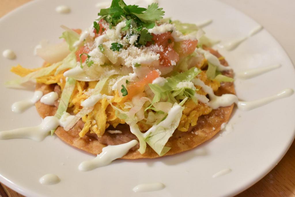 Tostadas · Crispy tortilla with spread of beans. Your choice of meat topped with lettuce, pico de gallo, sour cream, grated cheese and salsa.