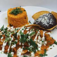 Chilaquiles · Tortilla chips soaked in red or green salsa with rice or beans, topped with asada or 2 eggs,...