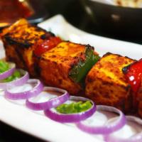 84. Tandoori Paneer Tikka · A vegetarian delight, homemade cottage cheese marinated in mild Indian spices and cooked in ...