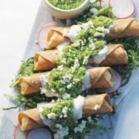 Flautas de Pollo · Fried tacos, filled with chicken and on top covered with Mexican cream an cheese.