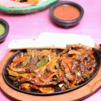 Steak Fajita · Steak fajitas, served with rice, beans, guacamole, pico de gallo, sour cream and tortilla.