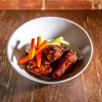 Buffalo Jerk Strivers Wings · Jerk seasoning, housemade Buffalo sauce, and carrots or celery garnish.